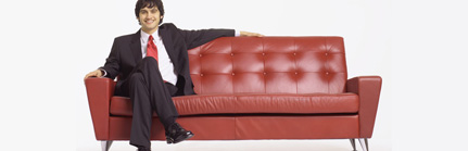 Man in Suit Sitting on Sofa